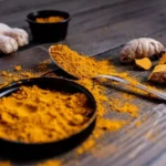 Turmeric root and powder, rich in Curcumin, a compound known for its numerous health benefits.