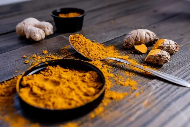 Turmeric root and powder, rich in Curcumin, a compound known for its numerous health benefits.