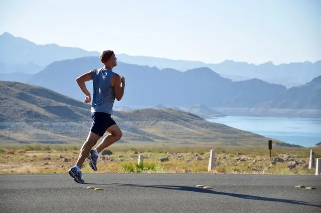 Man running in open field. Physical activity can help your body to detoxify naturally