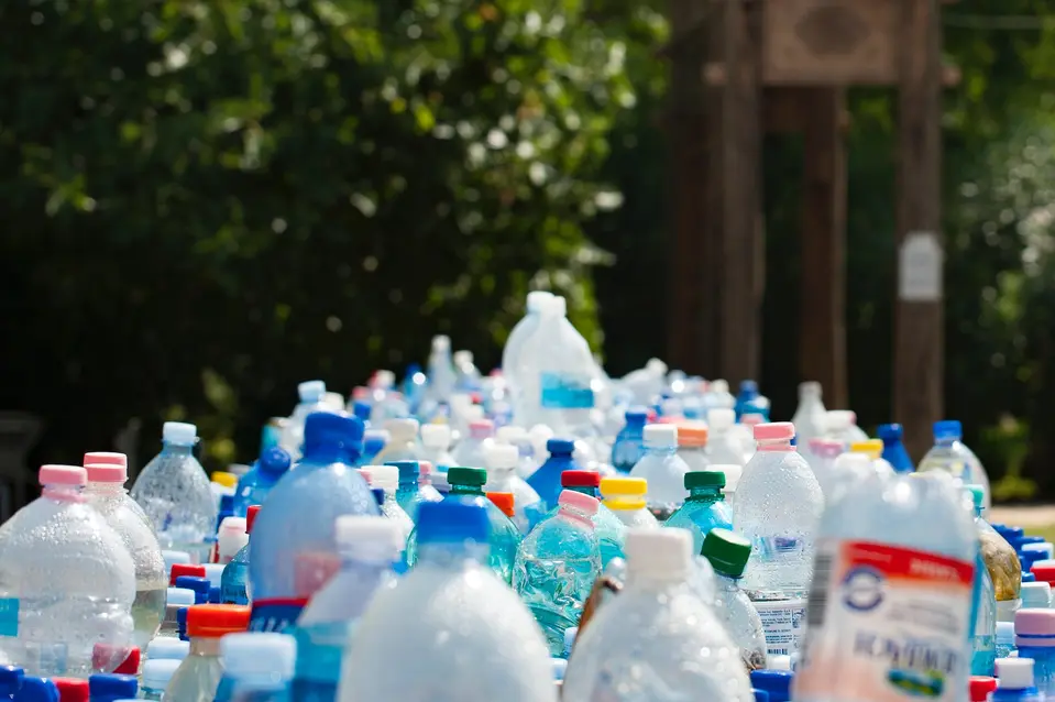 Lots of plastic bottles and packing in waste basket