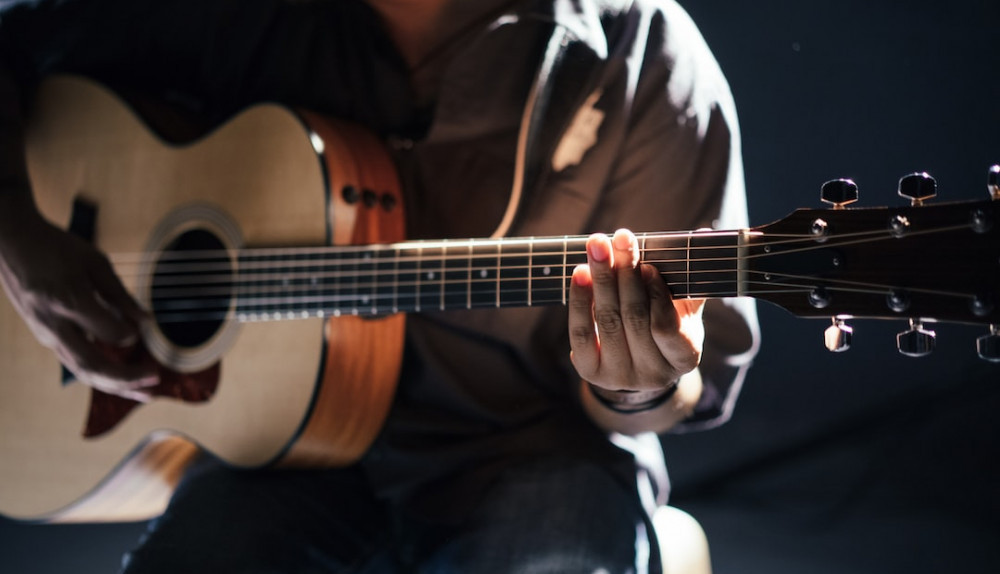 Image of a man playing guitar