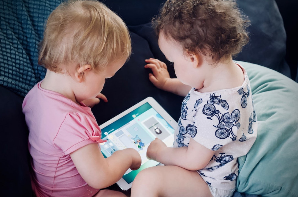 Image of children playing with a tablet