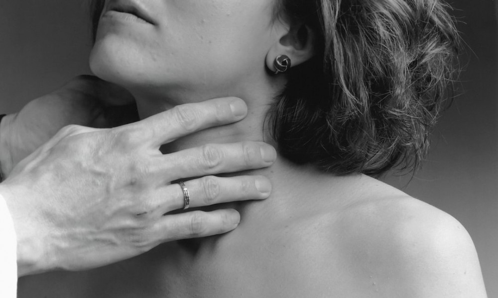 Image of a doctor touching the neck of a woman