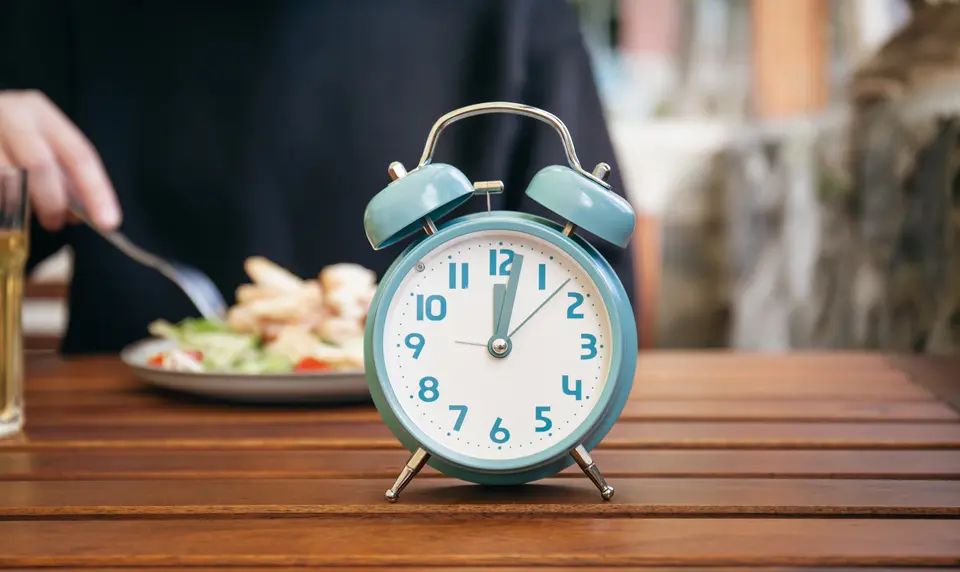 Close-UP Alarm Clock with food background - Fasting