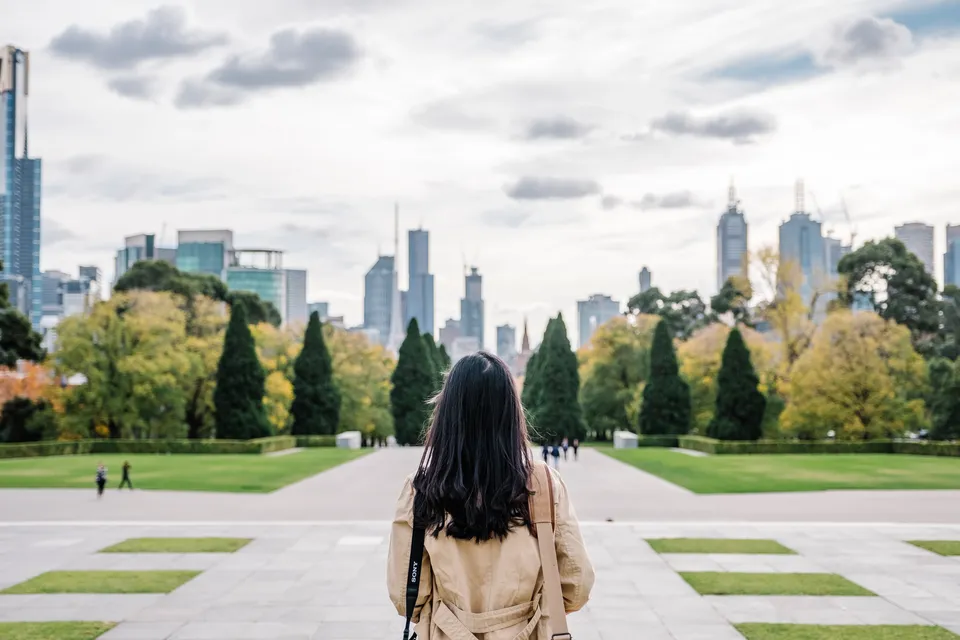 Woman in front of a large city