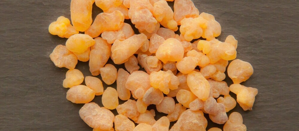 Close-up of raw frankincense pieces, showcasing their natural resin form, often used for their therapeutic properties in essential oils.