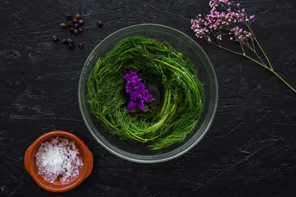 Close-up of a bowl with vibrant green chlorella algae on a rustic table, highlighting the detox power of chlorella.